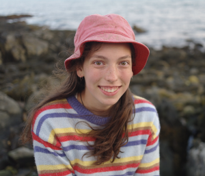 Chloe Gilligan headshot in front of the shoreline