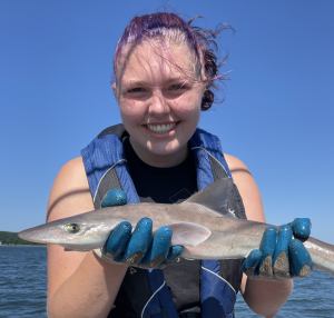 Rhiannon Moore holding a fish out of the water